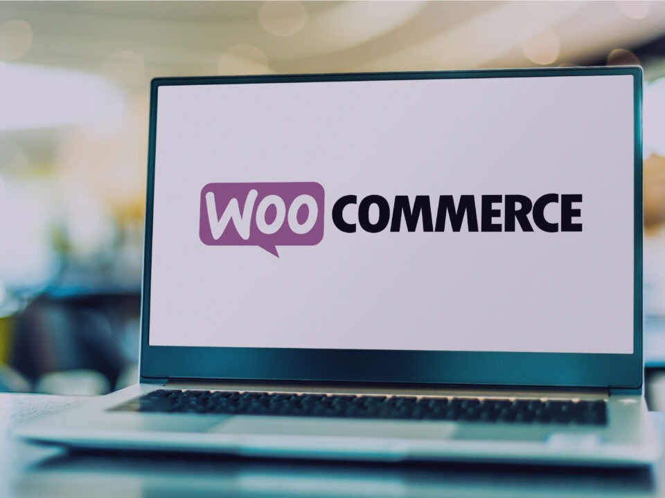 WooCommerce logo displaying on a laptop